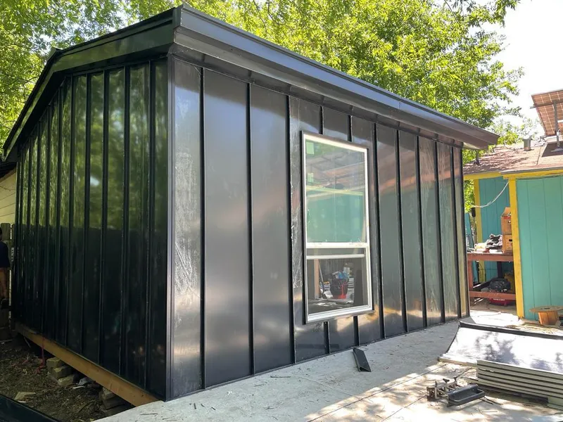 Black standing seam metal wall panels for Roof Inspection in Green